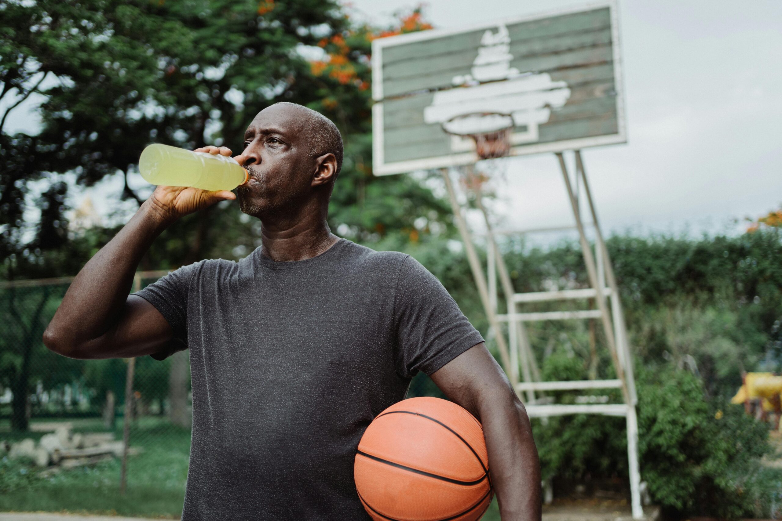 man drinking sports drink after basketball and before visiting dentist Cloverdale BC